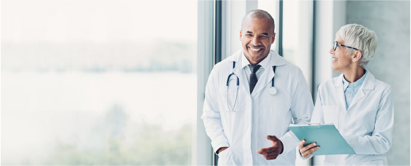 Two doctors talking and smiling.